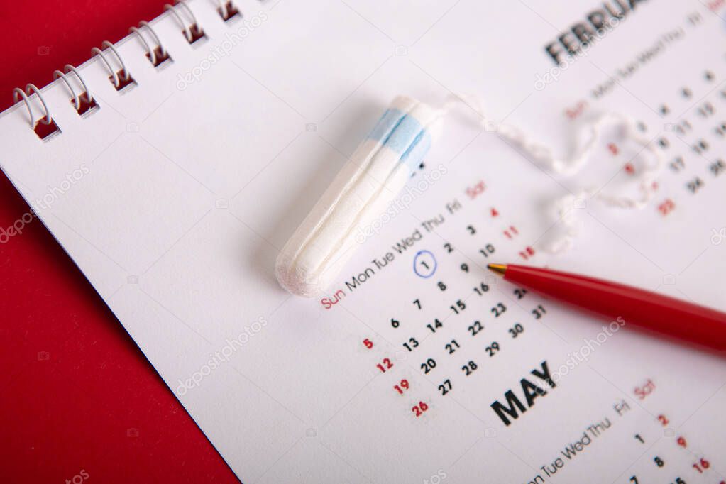 Medical female tampon on a pink background.