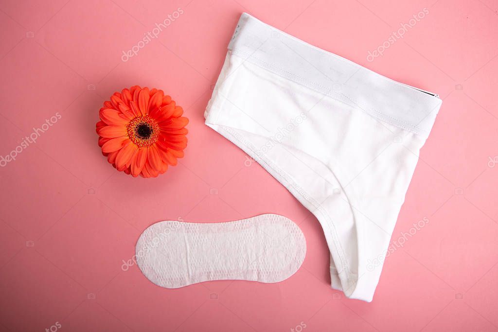 Medical female tampon on a pink background.