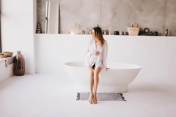 Beautiful sexy lady in elegant white shirt in a bathroom. — 스톡 사진