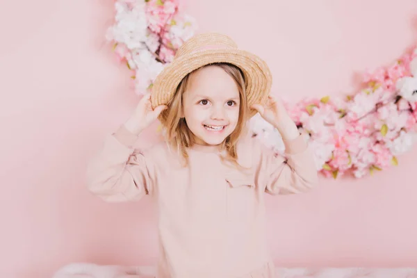 Image of sweet adorable girl with pink flowers in hat — Stock Photo, Image