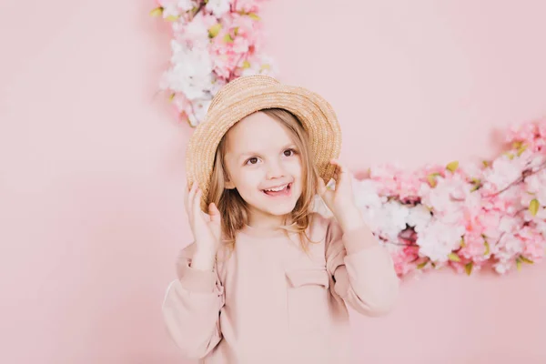 Image of sweet adorable girl with pink flowers in hat — Stock Photo, Image