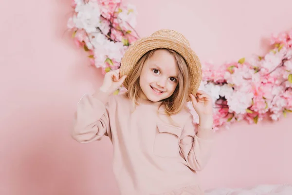 Image of sweet adorable girl with pink flowers in hat — Stock Photo, Image