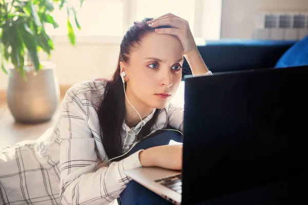 Upset, sad woman sitting at computer. Job search, crisis, unstable situation. Unemployed Jobless People Crisis, Stress, lose job. Despair office People feel Stressful in depress situation.