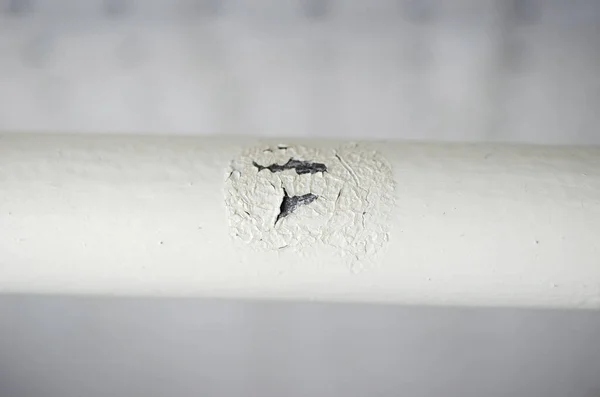 Corrosion on metal painted pipe. Heating pipe close-up.