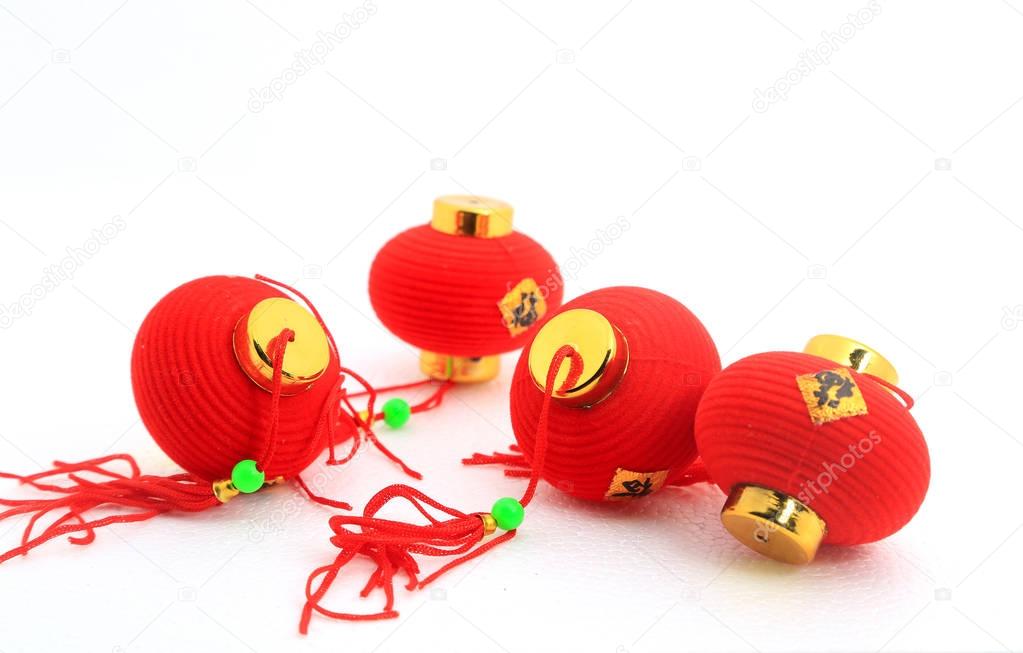 Group of small red Chinese lanterns for decoration over white background.  The chinese word means fortune.