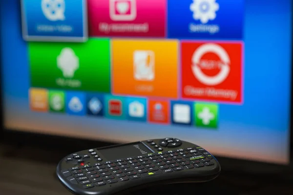 smart tv control device on the background of the TV screen