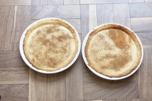 Beyaz kaselerde yenmeye hazır iki süt tartı yakın çekim görüntüsü. 