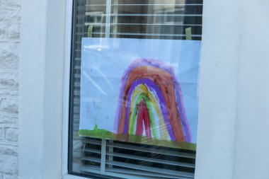 Bristol-March 2020-England-a close up view of rainbows that children and drawn and put up into thier windows to show hope for this time of lockdown during the C19 virus outbreak  clipart