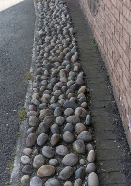 a close up view of stones concreted into a path on the side of the main road  clipart