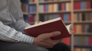 A man reads a book in the library
