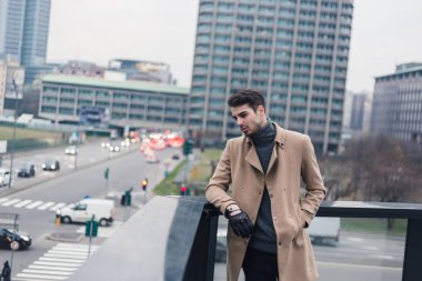 Güzel genç adam bir kentsel bağlamda poz