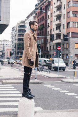 Güzel genç adam bir kentsel bağlamda poz