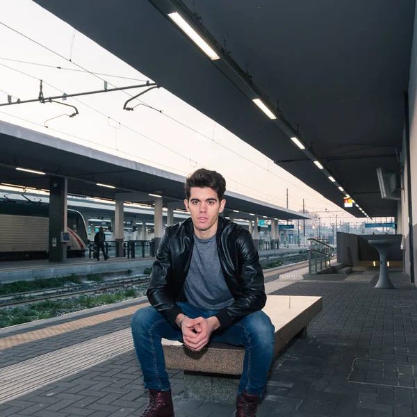 Schöner junger Mann posiert in einem Bahnhof — Stockfoto