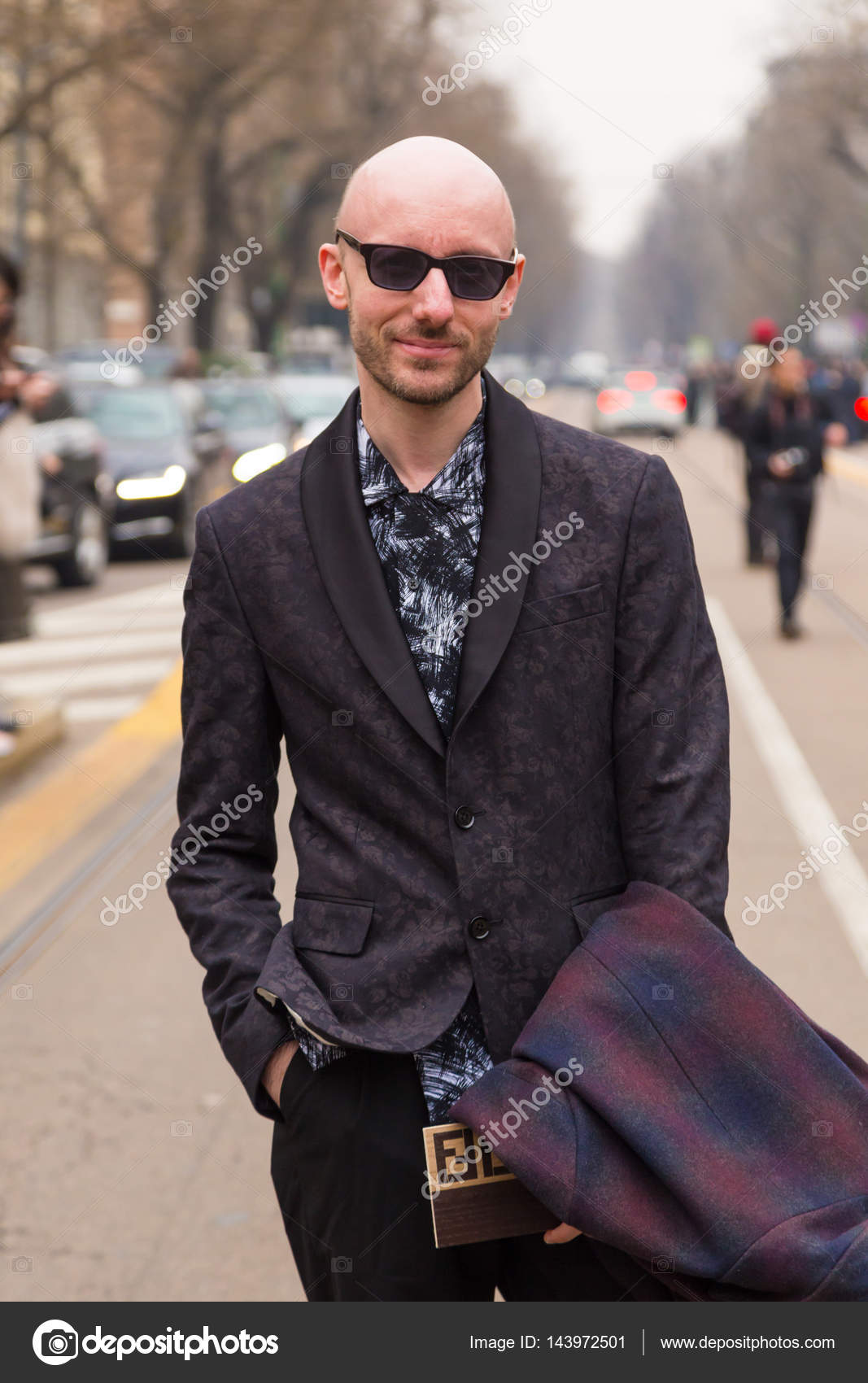 Fashionable man posing during Milan Women\u0027s Fashion Week