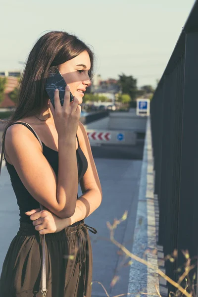 Ung kvinna pratar i telefon — Stockfoto