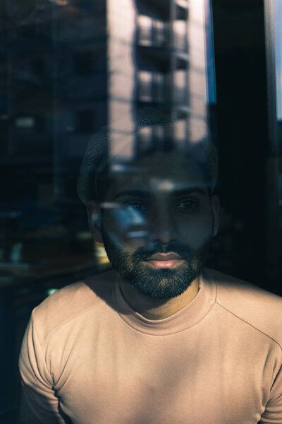 Portrait of an Indian man posing behind a glass — Stock Photo, Image