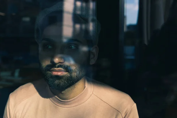 Portrait of an Indian man posing behind a glass — Stock Photo, Image