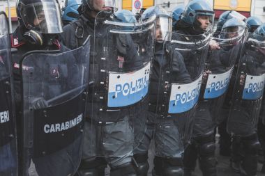 Riot police confronting activists in Milan, Italy clipart