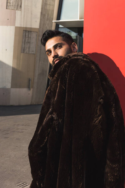 Young Indian man posing in an urban context