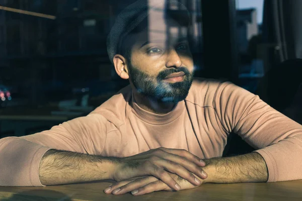 Portrait of an Indian man posing behind a glass — Stock Photo, Image