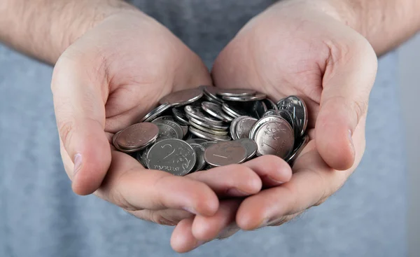 Russian rubles in the form of coins in the hands of man — Stock Photo, Image