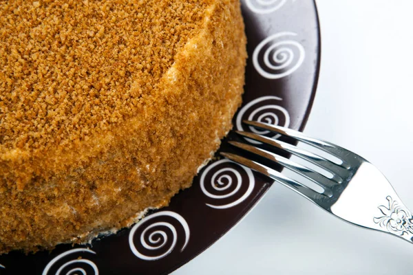 Whole cream cake on the plate and fork — Stock Photo, Image