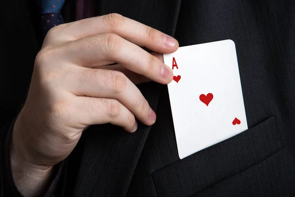 man pulls out a playing card out of his pocket