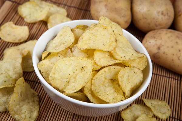 Still life from a glass bowl with potato chips — Stock Photo, Image