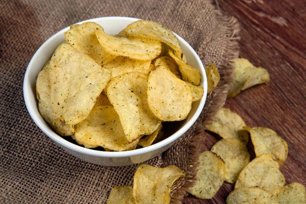 Still life from a glass bowl with potato chips — Stock Photo, Image