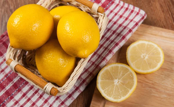 Still life of fresh lemons in a basket — Stock Photo, Image