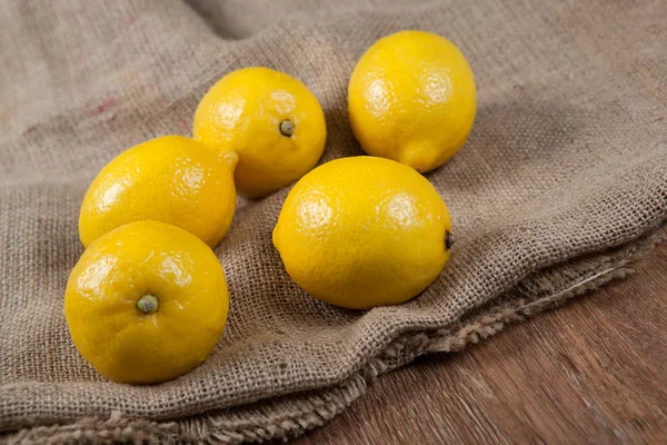 Still life of fresh lemons on a bag — Stock Photo, Image