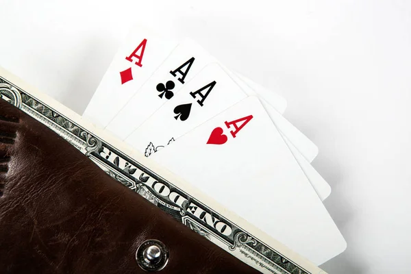 Four cards with aces and a dollar bill in a purse — Stock Photo, Image