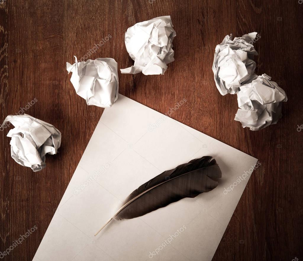 still life of paper and a crumpled paper on a table with a pen