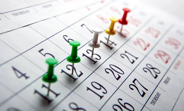 Large wall calendar with colored needles — Stock Photo, Image