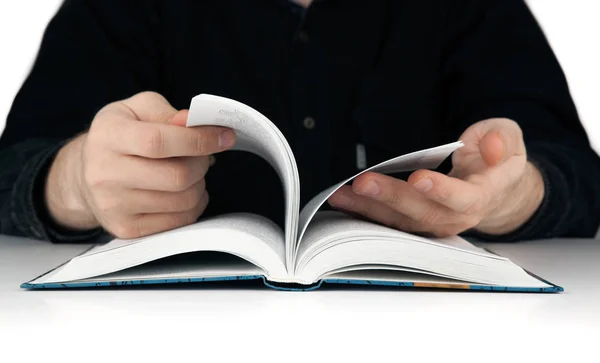 Men's hands flipping through the pages of the book — Stock Photo, Image
