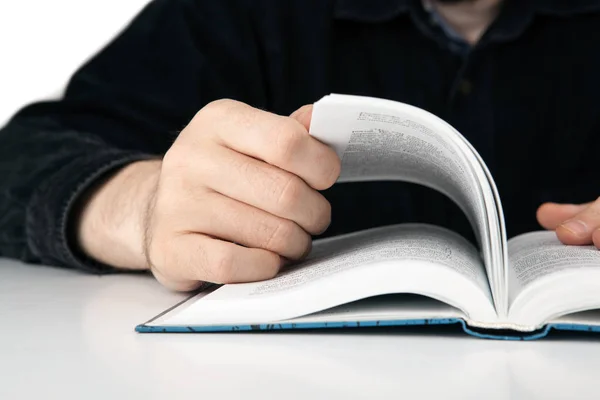 Hands of a man thumbing a book close seup — стоковое фото