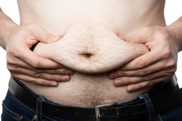 一个男人在他的大肚子上感觉到他的脂肪 — 图库照片