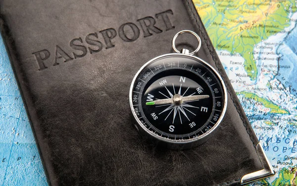 compass passport in cover and world map