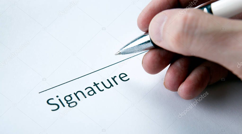 One document with a place for a signature and a hand of a man wi