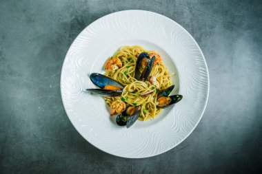 Taş tezgahın üstünde karides ve midyeli lezzetli bir makarna..