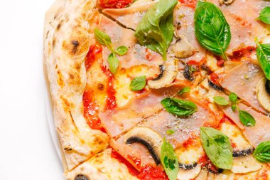 Jambonlu, mantarlı ve fesleğenli peynirli pizza. Yakın plan. Beyaz arkaplan.