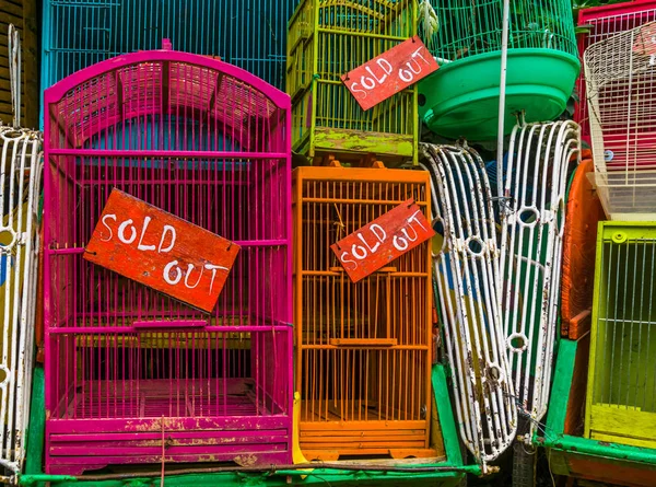 bird cages with sold out signs in closeup, Pet trade in Asia, Animal business background