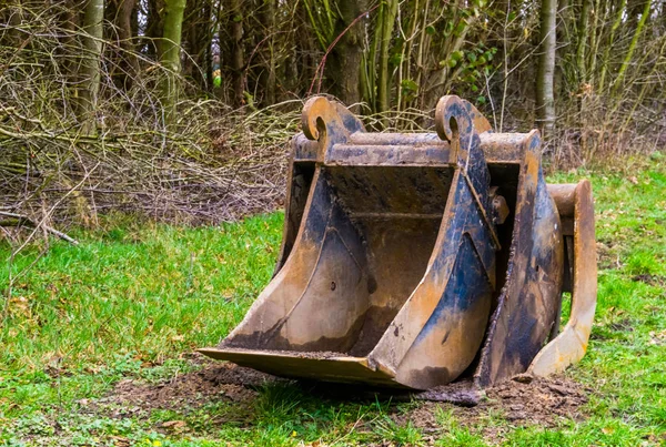 Stack of scoops in different sizes, equipment for the excavator, earthmoving industry background — ストック写真