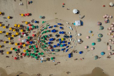 Sahilde şemsiyelerin altındaki insanların sanatsal taklidi.