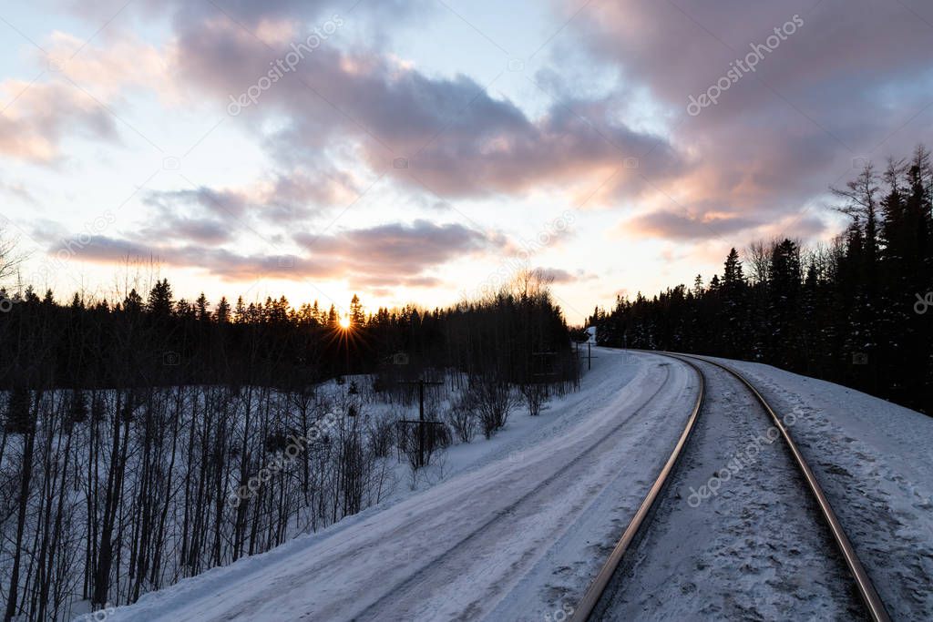 Sunset over winter train tracks