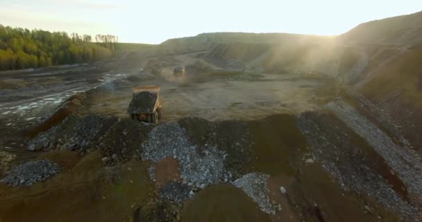 Dump trucks unload the ground and stones — Stock Footage Dump trucks unload the ground and stones Royalty Free Stock Video