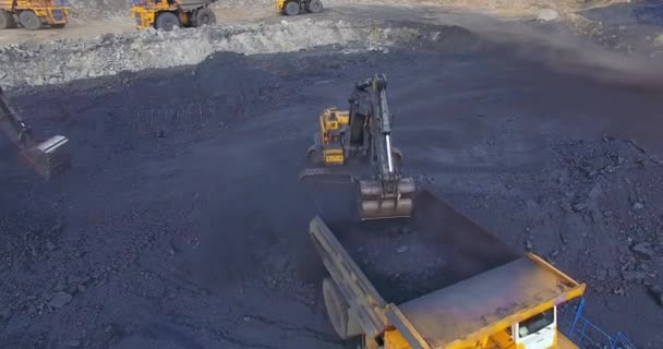 View from copter excavator loads coal into dump truck — Stock Footage View from copter excavator loads coal into dump truck Stock Footage