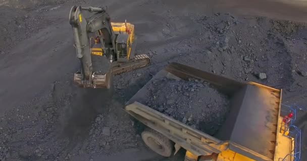 Fly over around, excavator loads coal into dump truck — Stock Footage Fly over around, excavator loads coal into dump truck Stock Footage