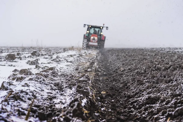 Preparing land for sowing in snow — Stock Photo, Image