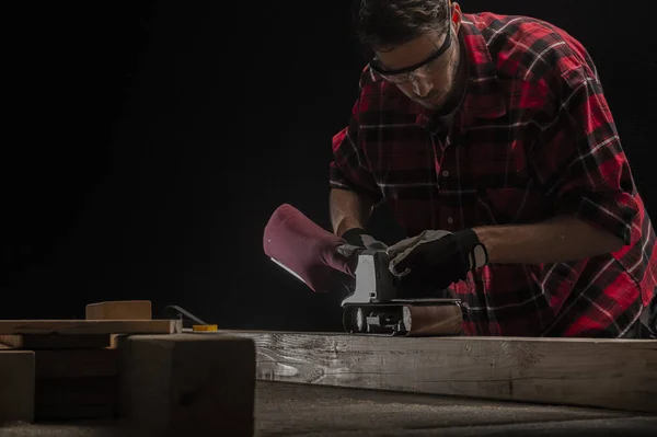 Carpenter works with electrical planer — Stock Photo, Image